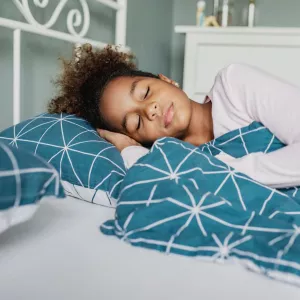 A Young Girl Sleeps Soundly in Her Bed